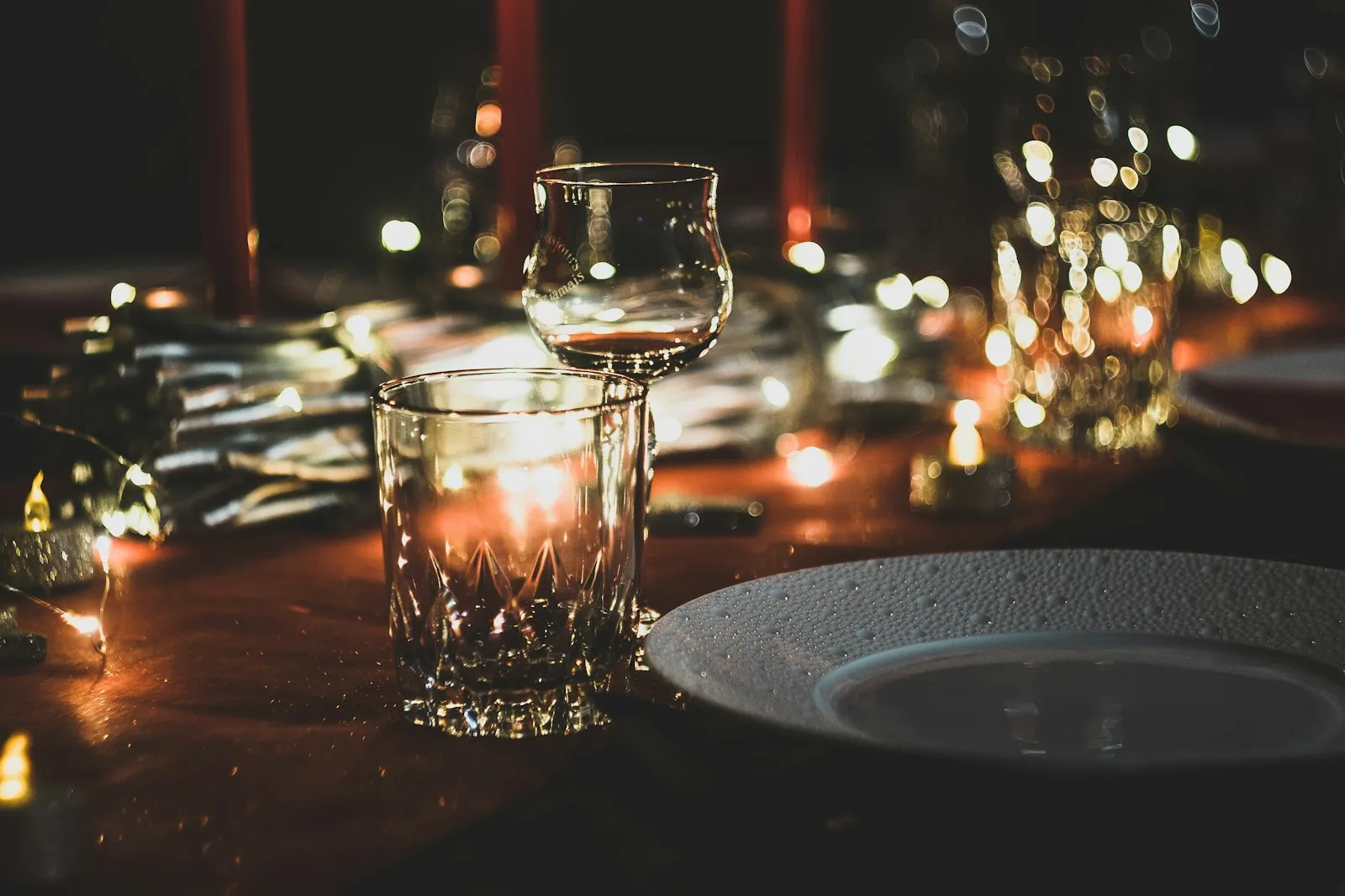 Candlelit glassware on a dinner table