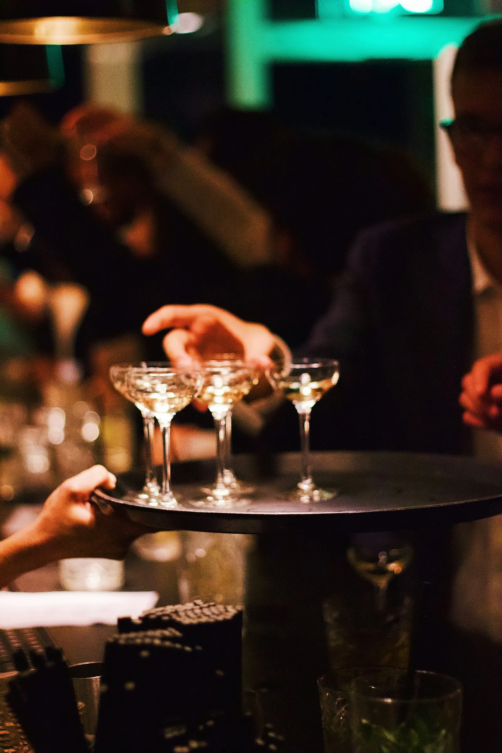 Cocktail tables with linens, uplighting, a sound kit and a branded photo wall.