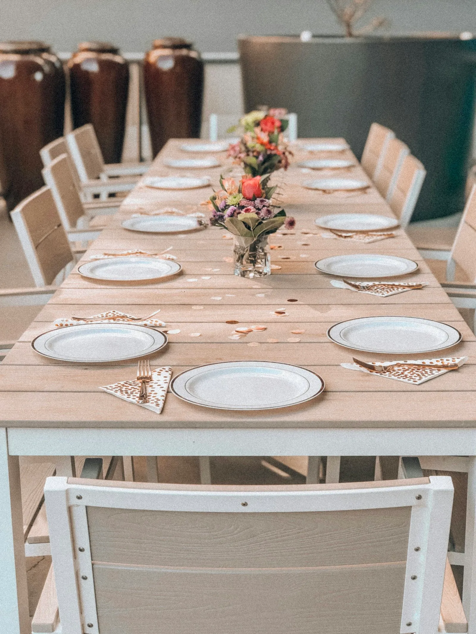 Olive and ivory linens, bud vases, a floral backdrop and lounge corner.