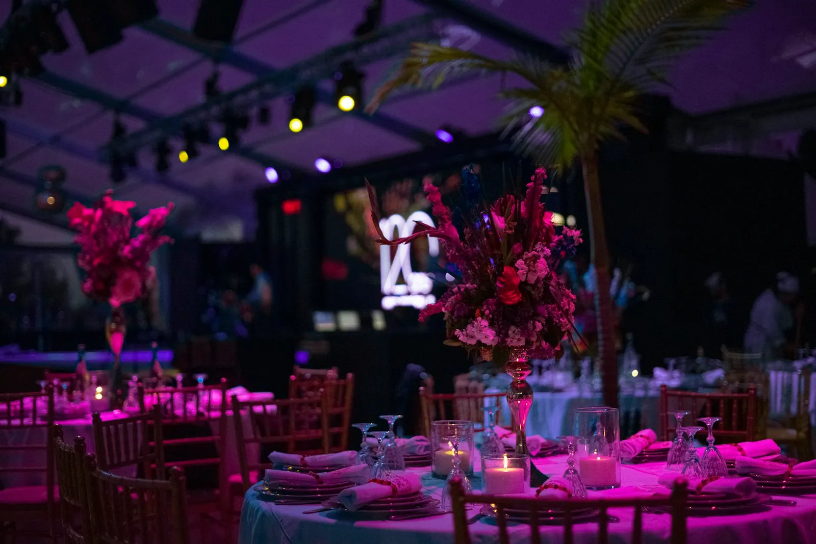 Uplighting, string lights and a speaker with mic. A plain hall, transformed.